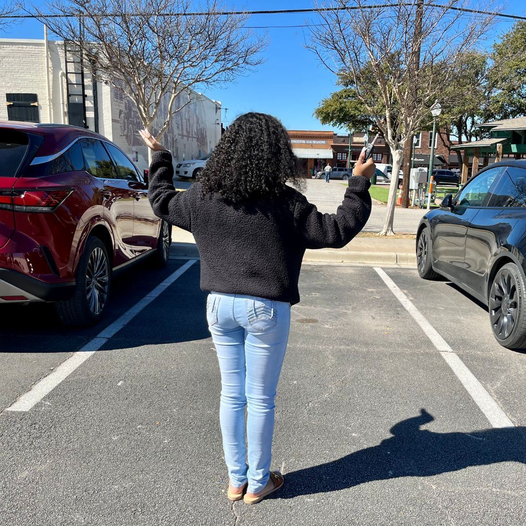 woman standing in front of empty parking spot